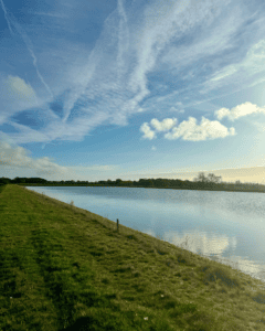 Place UK's reservoir in Norfolk, filled with rainwater on a sunny day.