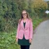 Kelly Jay, Place UK's head of finance, standing in Norfolk Country lane.