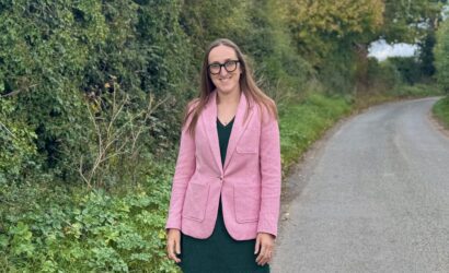 Kelly Jay, Place UK's head of finance, standing in Norfolk Country lane.
