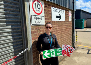 Place UK's Health and Safety Advisor Antoaneta holding signs on site.