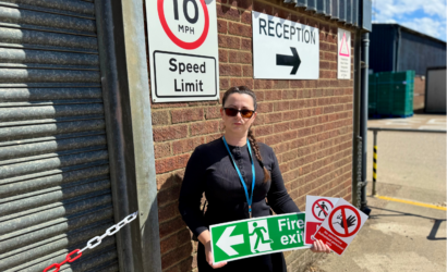 Place UK's Health and Safety Advisor Antoaneta holding signs on site.